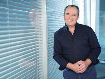 Wolfram Kons Wolfram Kons leans casually against a window.