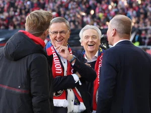 Roland and Jürgen Mack together with Jochen Saier and Oliver Leki, chairman of SC Freiburg, on the pitch at the Europa-Park Stadion in Freiburg.