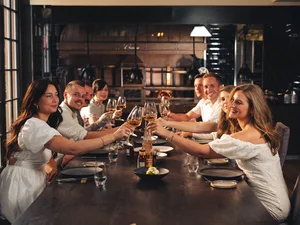 Wine at restaurant Amité Guests toast with wine glasses at the Amitié – La Cuisine du Château restaurant.