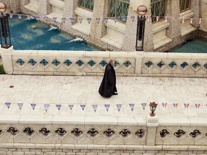 Michael Mack FOCUS STYLE Michael Mack walks through the Croatian themed area wearing a long, dark coat.