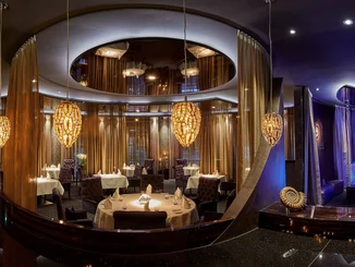 The elegant interior of Ammolite - The Lighthouse Restaurant The elegant dining area of Ammolite bathed in warm light.