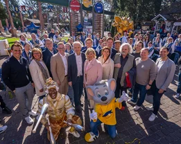 The Mack family with a band, Ed Euromaus and an artist in front of the fountain in the German themed area.
