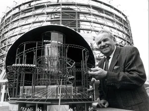 Franz Mack presents a model of Eurosat in front of the construction site. Franz Mack with a model of Eurosat in front of the construction site, showing a cross-section of the attraction.