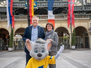 Roland and Marianne Mack Roland Mack stands with his wife Marianne Mack and Ed Euromaus in front of the main entrance to Europa-Park.