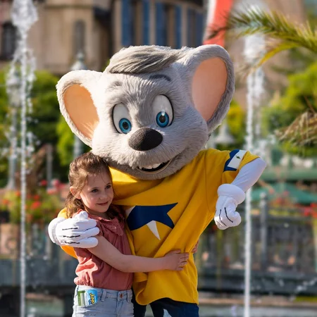 Europa-Park JUNIOR CLUB Child hugs Ed Euromaus, the mascot of Europa-Park.